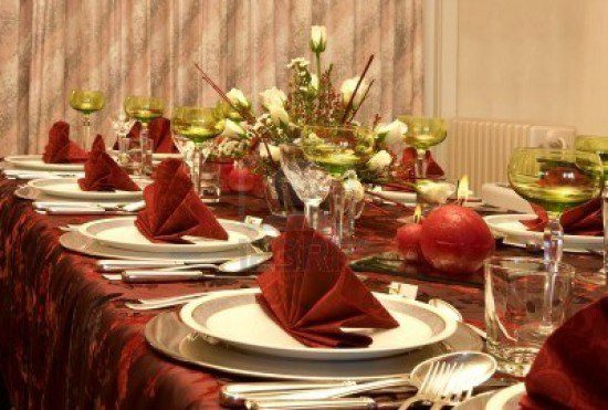 3744505-christmas-dinner-table-with-flowers-and-red-napkins